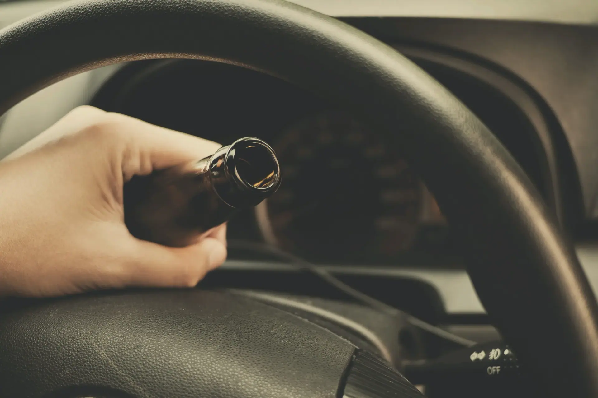 Man drink beer while driving car. Driving in a state of intoxication.don't drink and drive concept