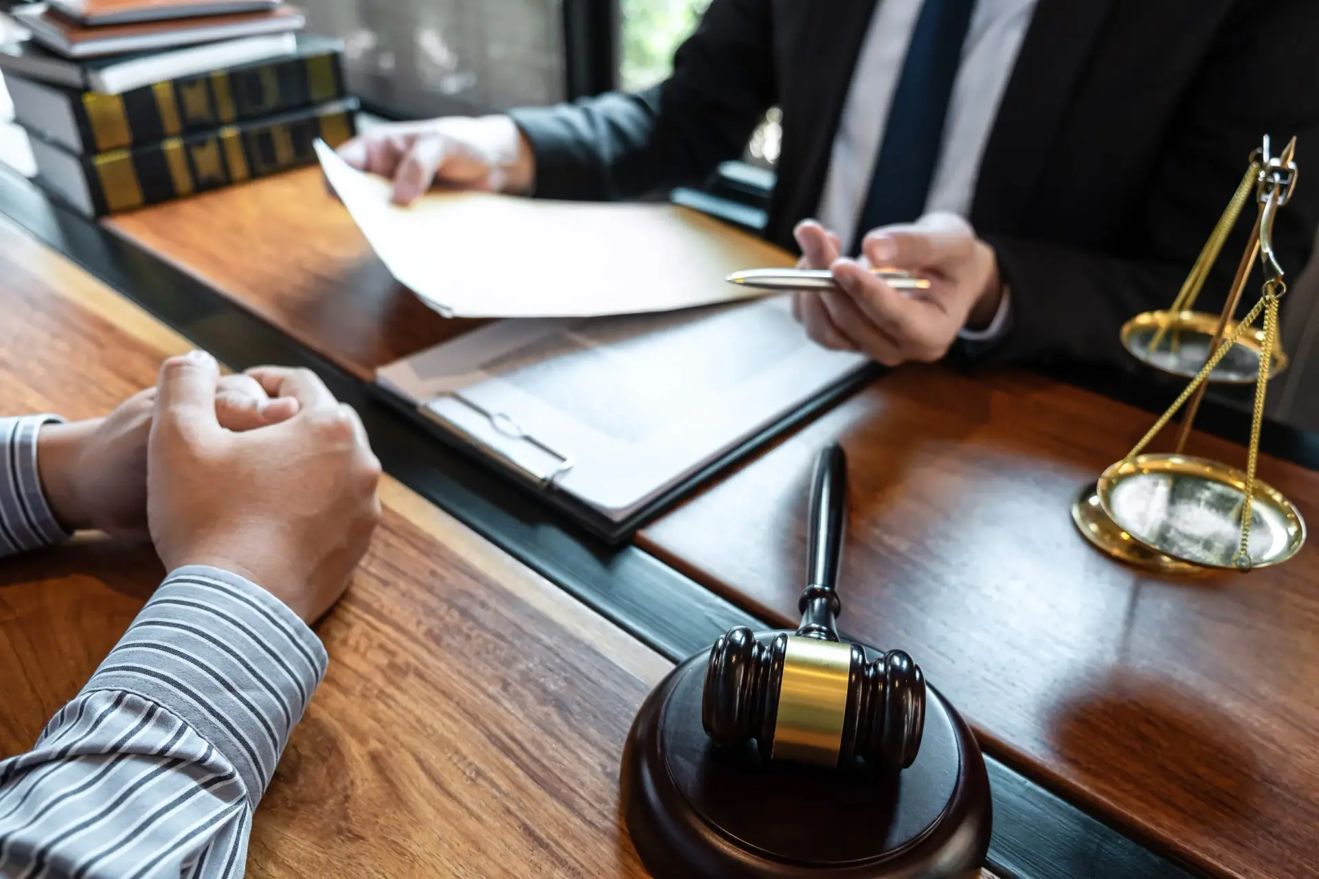 Male lawyer discussing negotiation legal case with client meeting with document contact in courtroom, law and justice concept